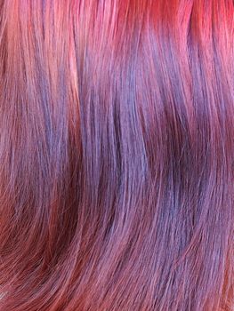dyed red female hair closeup, texture for background.