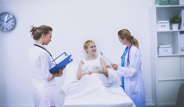 Young woman doctor standing at hospital with medical stethoscope.