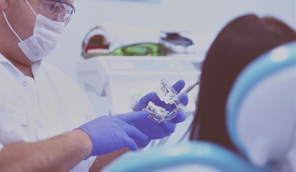 Beautiful senior woman at dentist having dental treatment at dentist's office.