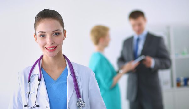 Woman doctor standing with stethoscope at hospital .