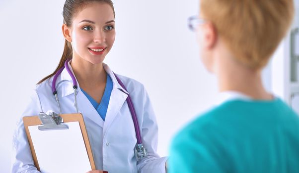 Woman doctor standing with folder at hospital .