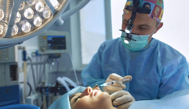 Man surgeon at work in operating room.