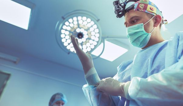 Man surgeon at work in operating room.