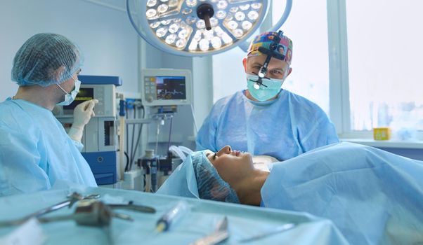 Man surgeon at work in operating room.