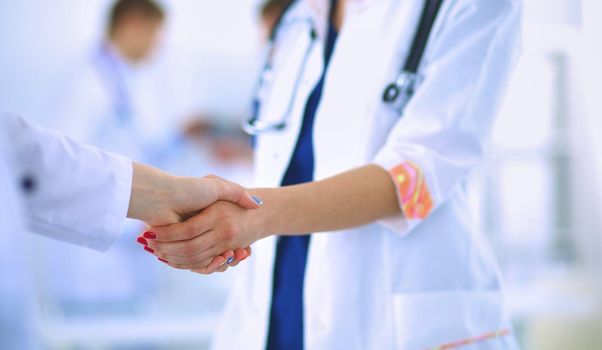 Young medical people handshaking at office .