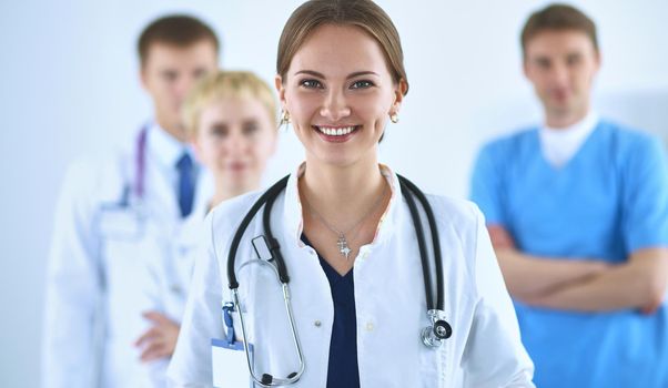 Attractive female doctor in front of medical group .