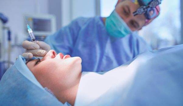 Man surgeon at work in operating room.