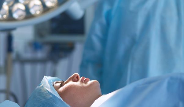 Man surgeon at work in operating room.