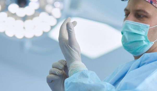 Man surgeon at work in operating room.