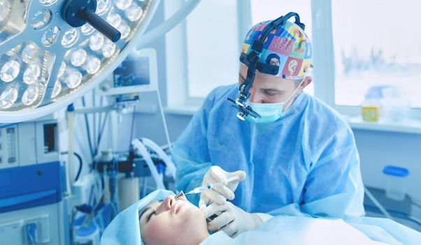 Man surgeon at work in operating room.
