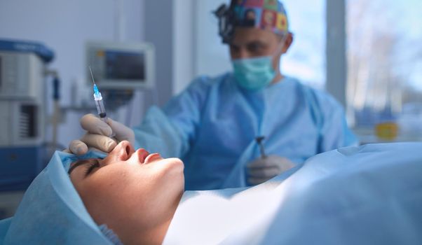 Man surgeon at work in operating room.