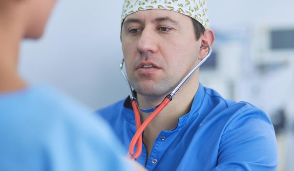 Man surgeon at work in operating room.