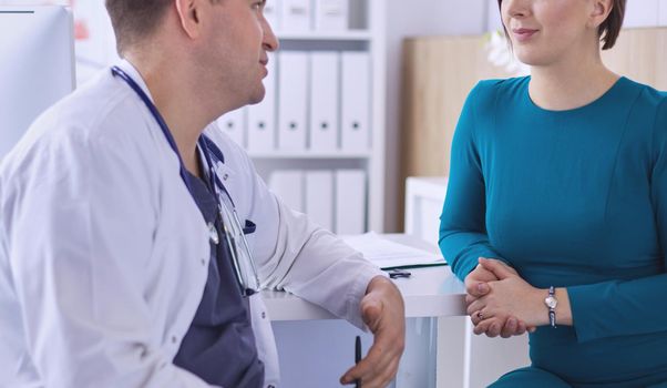 The patient and his doctor in medical office.