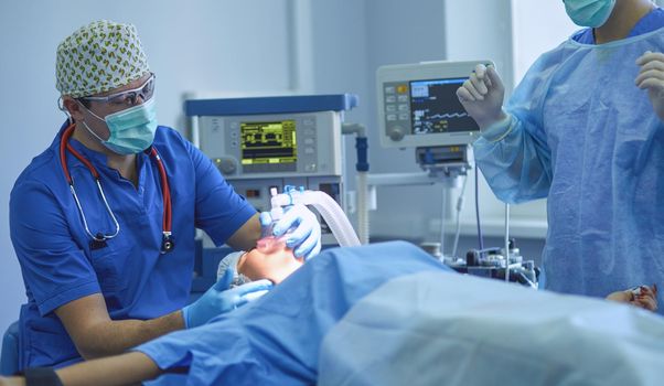 Man surgeon at work in operating room.