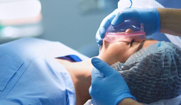Man surgeon at work in operating room.