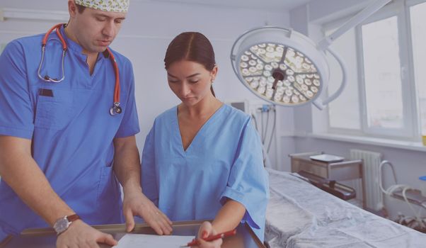 Man surgeon at work in operating room.