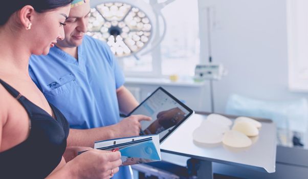 Doctor showing young patient her chest in his office at the hospital.