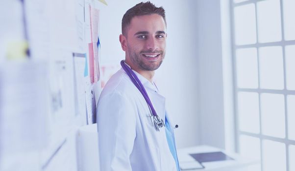 Young and confident male doctor portrait standing in medical office