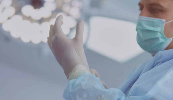 Man surgeon at work in operating room.