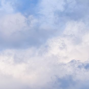 Background of cloudy sky with pale pink clouds at sunset