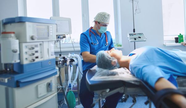 Man surgeon at work in operating room.