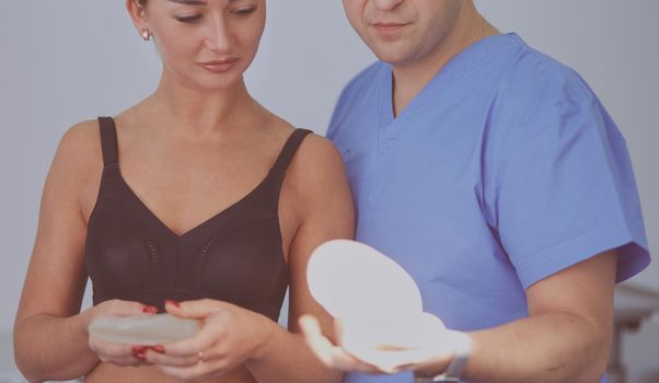Doctor showing young patient her chest in his office at the hospital.