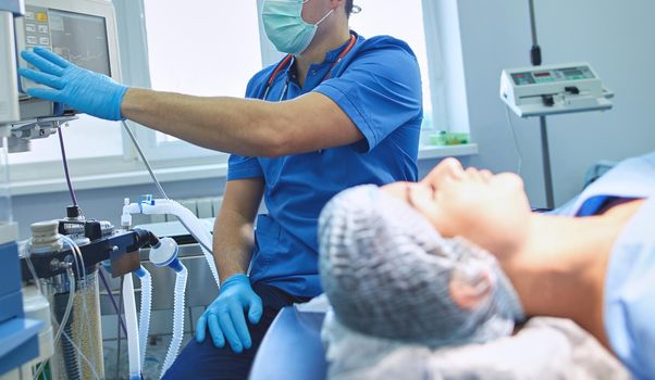 Man surgeon at work in operating room.