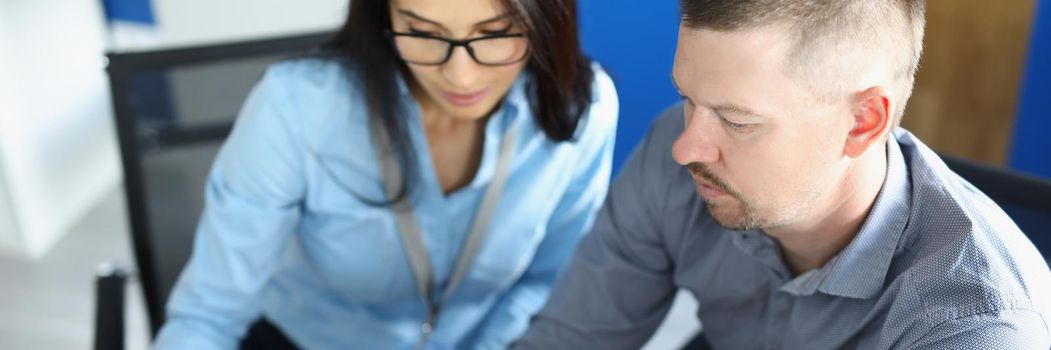 Portrait of coworkers and colleague work on new business project in office. Female employee use laptop, friendly communication in team. Office life concept