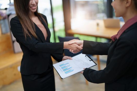 business merger, Asian businesswoman shake hands at the conference room with showcase their collaboration to strengthen their marketing efforts