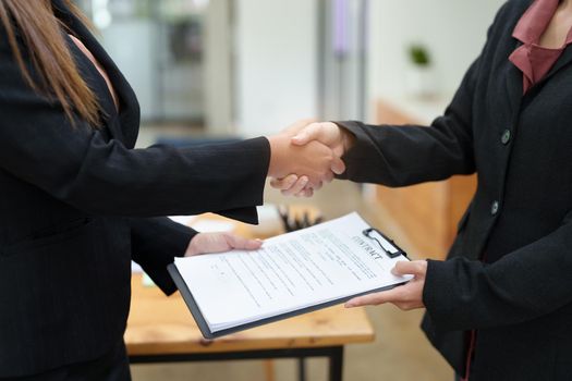 business merger, Asian businesswoman shake hands at the conference room with showcase their collaboration to strengthen their marketing efforts