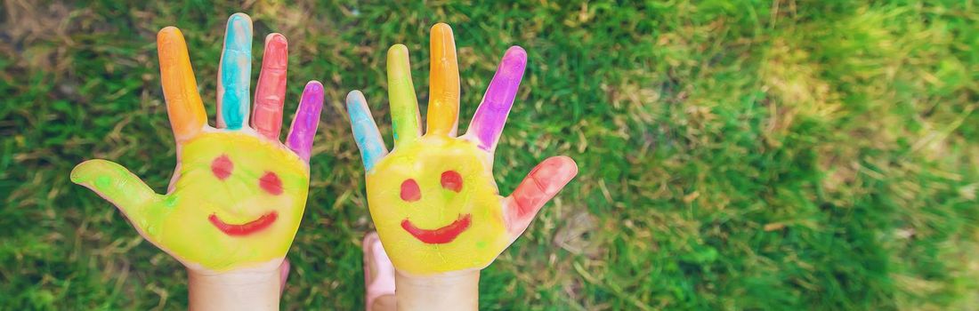 Children's hands in the colors of summer. Selective focus.arts