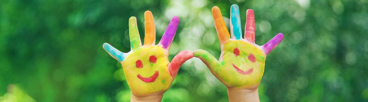 Children's hands in the colors of summer. Selective focus.arts