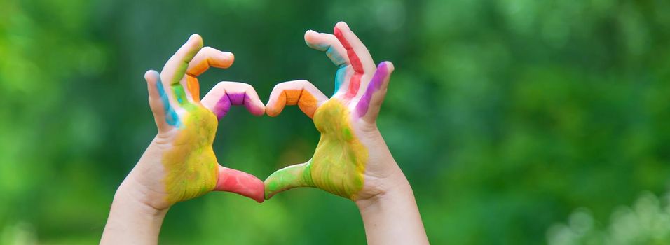 Children's hands in the colors of summer. Selective focus.arts