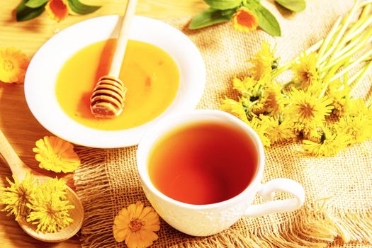 honey with dandelions. cup of tea with dandelion. selective focus.nature