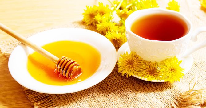 honey with dandelions. cup of tea with dandelion. selective focus.nature