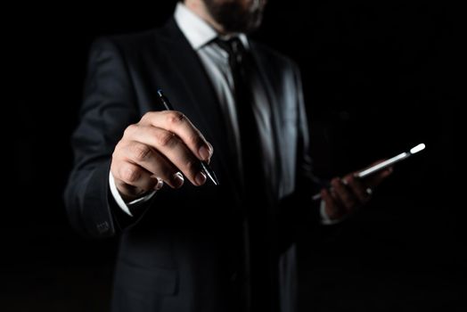 Businessman Holding Phone And Pointing Important Message With Pen.