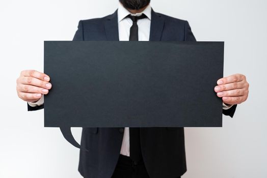 Businessman Holding Speech Bubble With Important Informations.