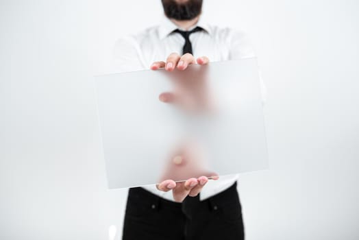 Man Holding Placard Presenting Marketing Strategies For Development.