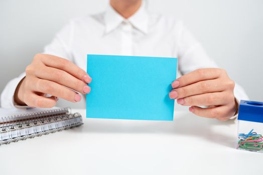 Businesswoman Holding Note With Important Message On Office Desk.