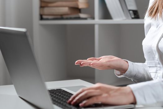 Woman Typing Recent Update On Lap Top And Holding Important Ideas Over Hand