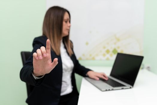 Woman Typing Updates On Lap Top And Pointing New Ideas With One Finger.