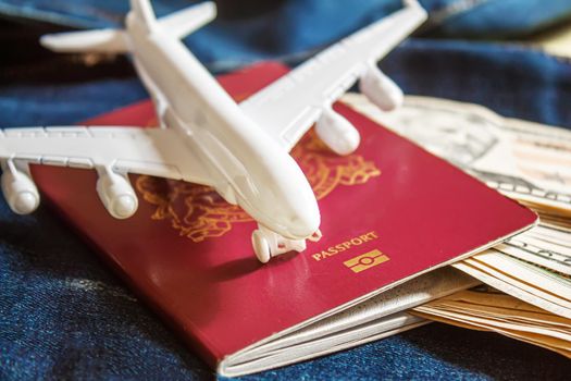 Travel preparation concept of airplane, money, passport, on yellow background. Selective focus.holidays