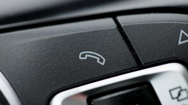 Bluetooth buttons located on the steering wheel of a car to talk over the phone hands free. Button car cell phone