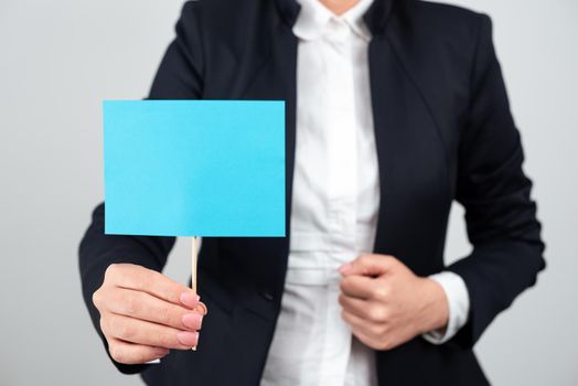 Businesswoman Presenting Important Message On Paper Attached To Stick.