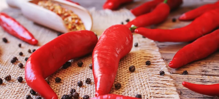 hot chili peppers on wooden background. selective focus.nature