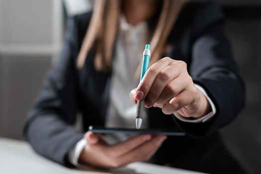 Woman Holding Tablet And Pointing With Pen On Important Idea.