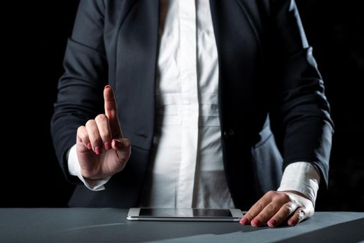 Businesswoman Having Tablet On Desk And Pointing New Ideas With One Finger.