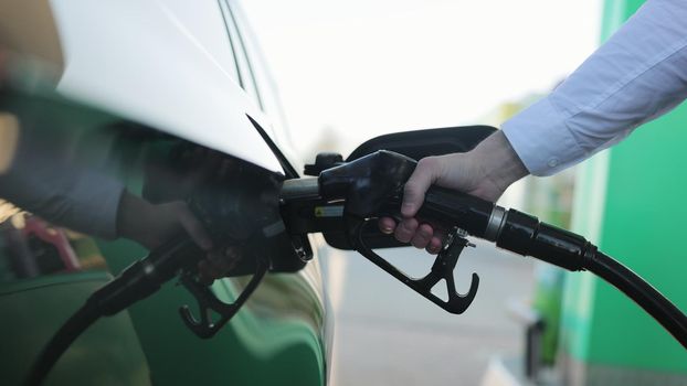 Filling car with gas fuel at station pump. Car filling up with fuel. Diesel Oil. Gas nozzle in car's fuel tank. Fuel, gas station, petrol prices concept