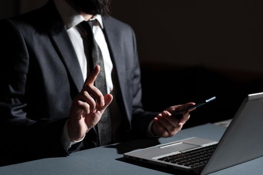 Man Holding Mobile Phone In Hand And Pointing With One Finger On Data.