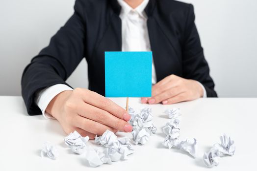 Woman Presenting Important Ideas On Pape With Crumpled Notes Around.